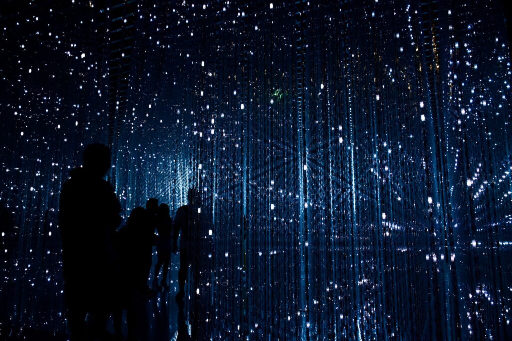 Atmospheric smart event setting with low lighting and scattered small lights, creating an immersive and experiential environment.