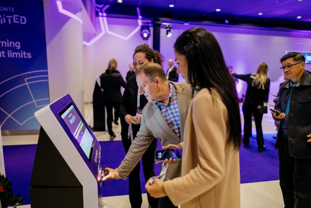 Attendee using a streamlined event badging system at a registration print-off station, demonstrating efficient check-in and badge creation