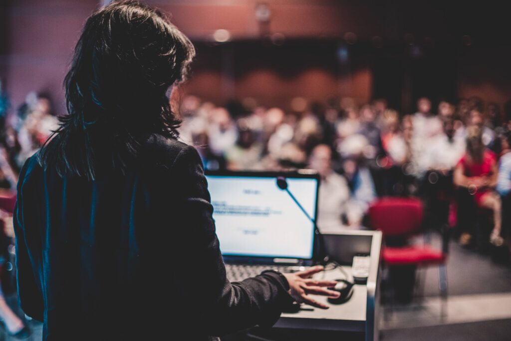 Speaker delivering clear, confident message to a focused event audience
