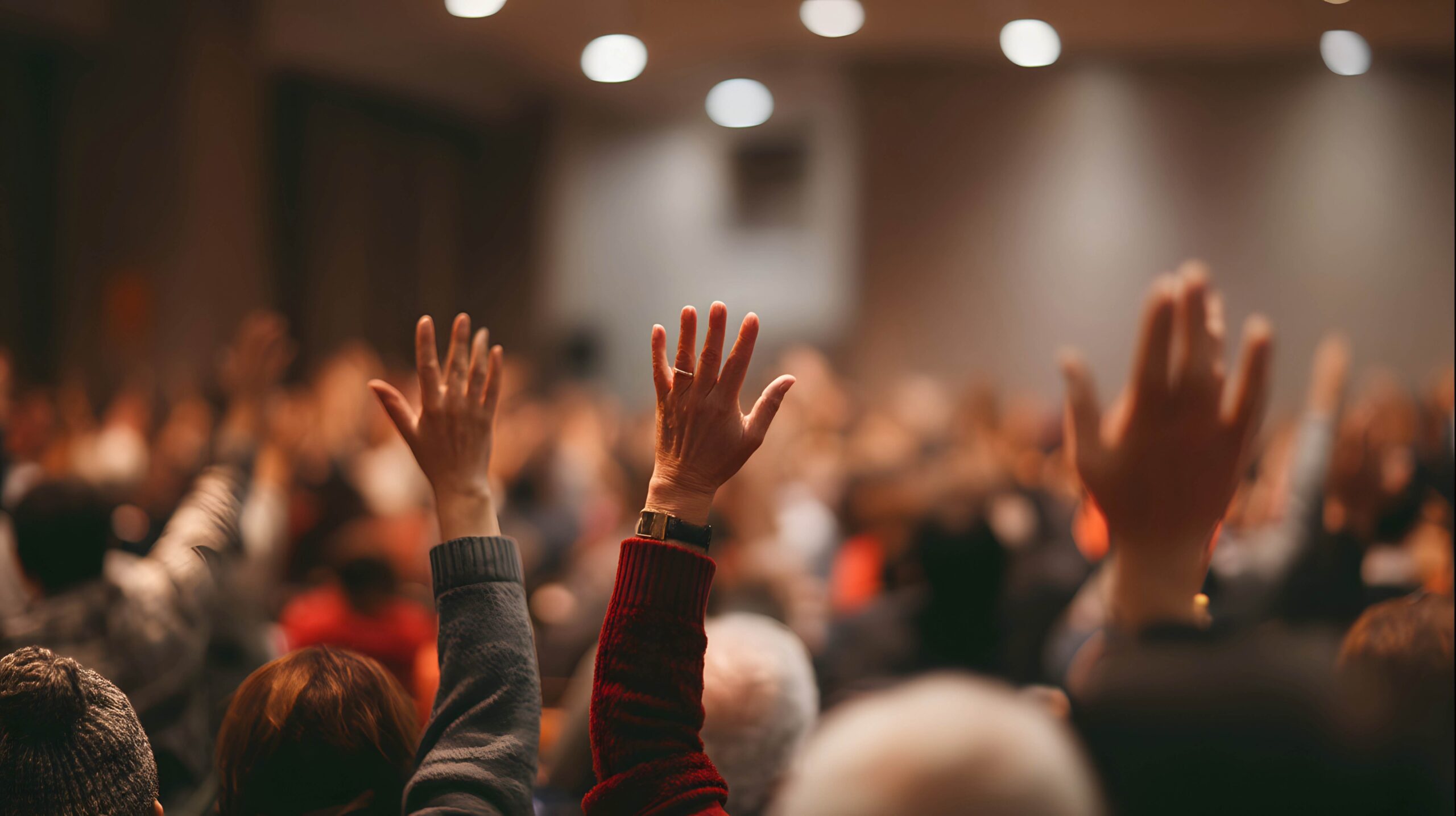 Event attendees putting hands up