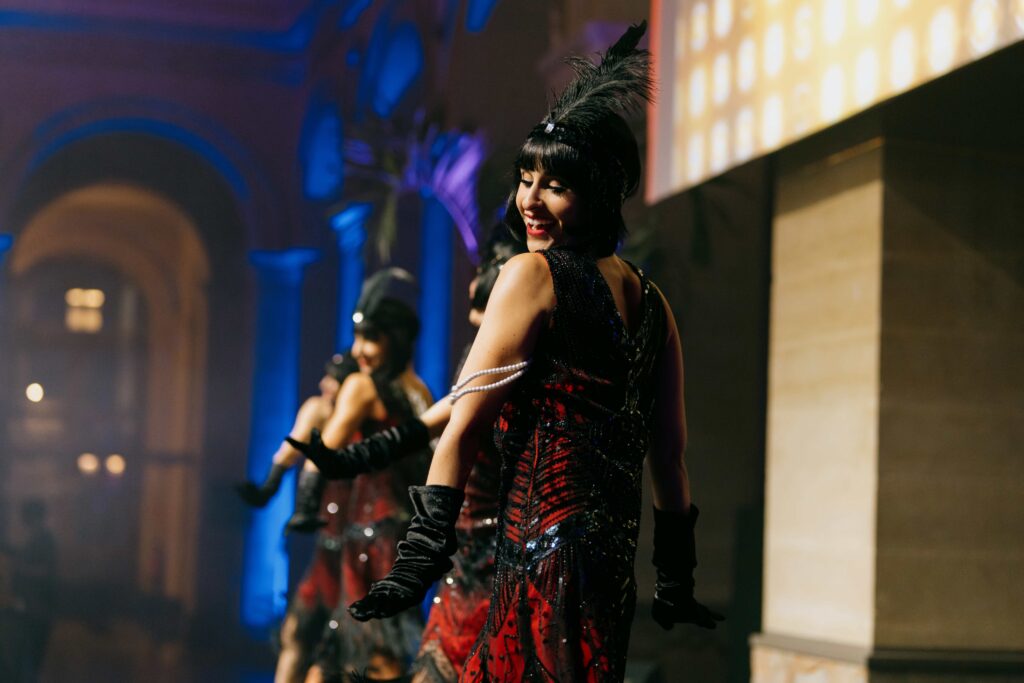 Live cabaret show at an event featuring a performer on stage with vibrant lighting and an engaged audience