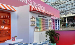 Canva brand activation kiosk styled like a retro American diner, with bold signage, pastel colours, and seating areas designed for interactive engagement.
