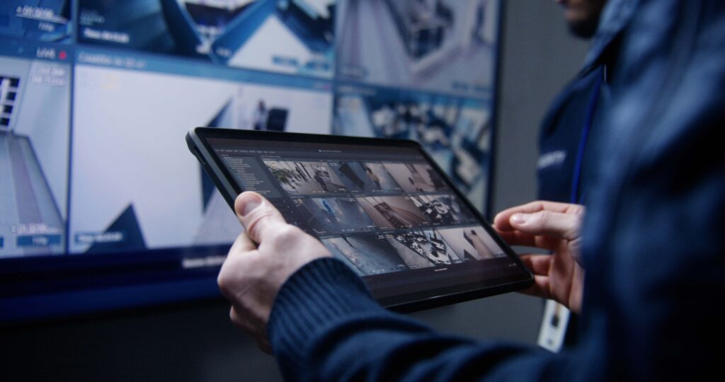 Event security staff monitoring multiple live camera feeds on a digital display with AI-powered surveillance support