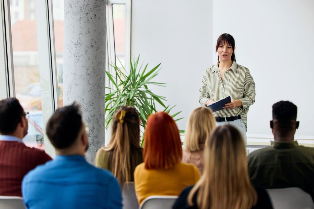 Speaker presenting at an event with an engaged audience paying close attention
