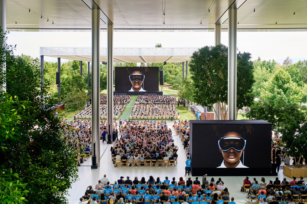 Audience watching the Apple WWDC 2025 keynote presentation, with screens and stage in the background