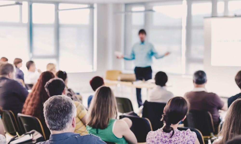 Professionals attending a CPD training event, engaging in group learning and discussion during a seminar