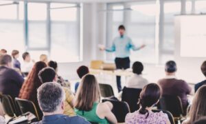 Professionals attending a CPD training event, engaging in group learning and discussion during a seminar