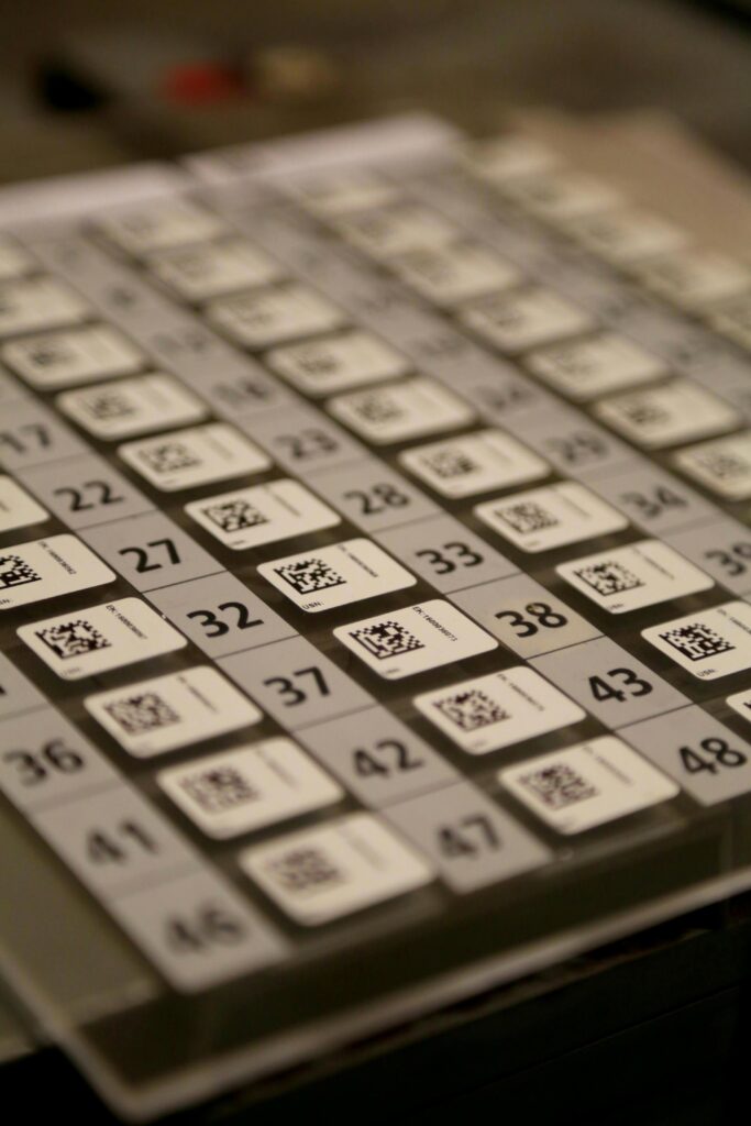 Multiple QR codes with numbers displayed beside them, representing digital event registration and attendee check-in.