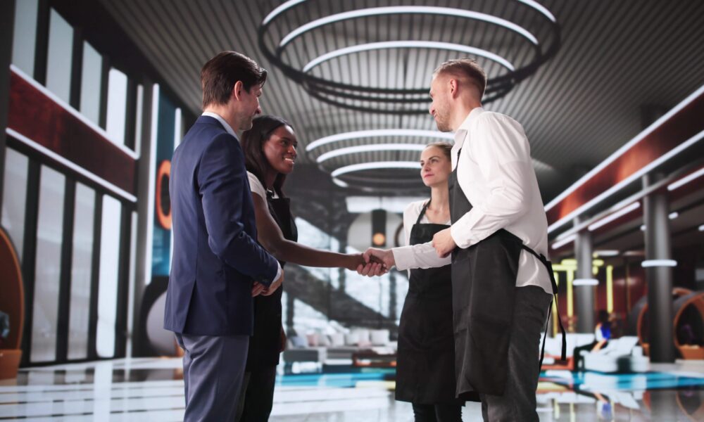 Business people shaking hands following new sponsorship agreement