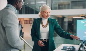 Sponsor engaging with a delegate at a live event – event sponsorship networking example