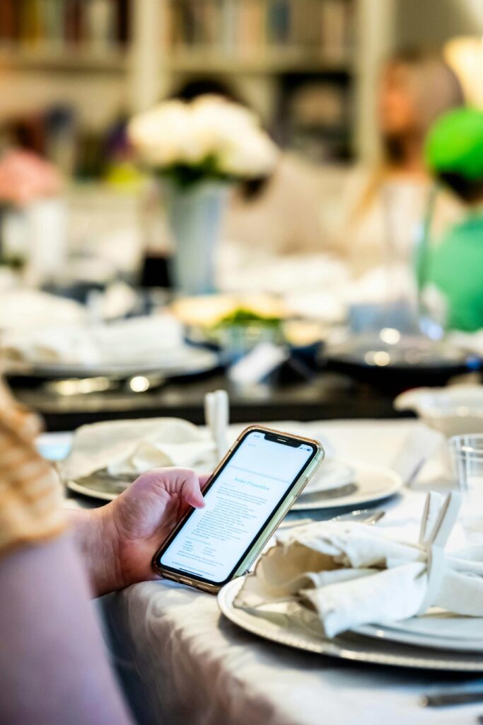 Mobile phone at event receiving event communications, signifying communications plan at event