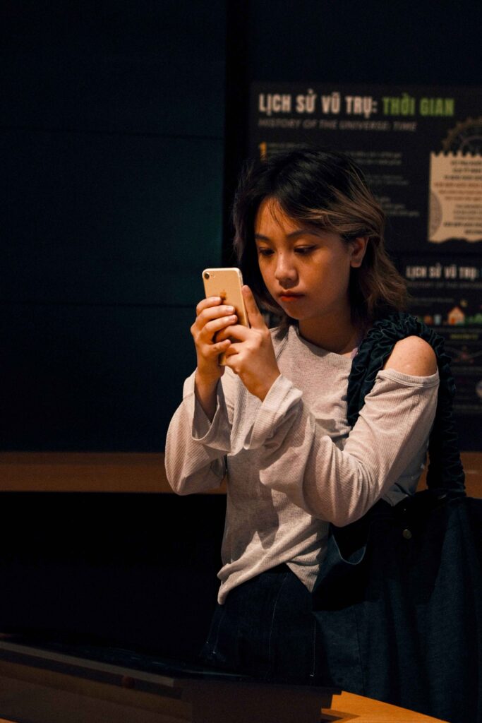 Event attendee on their phone. Event engagement ideas to make people put their phones down.