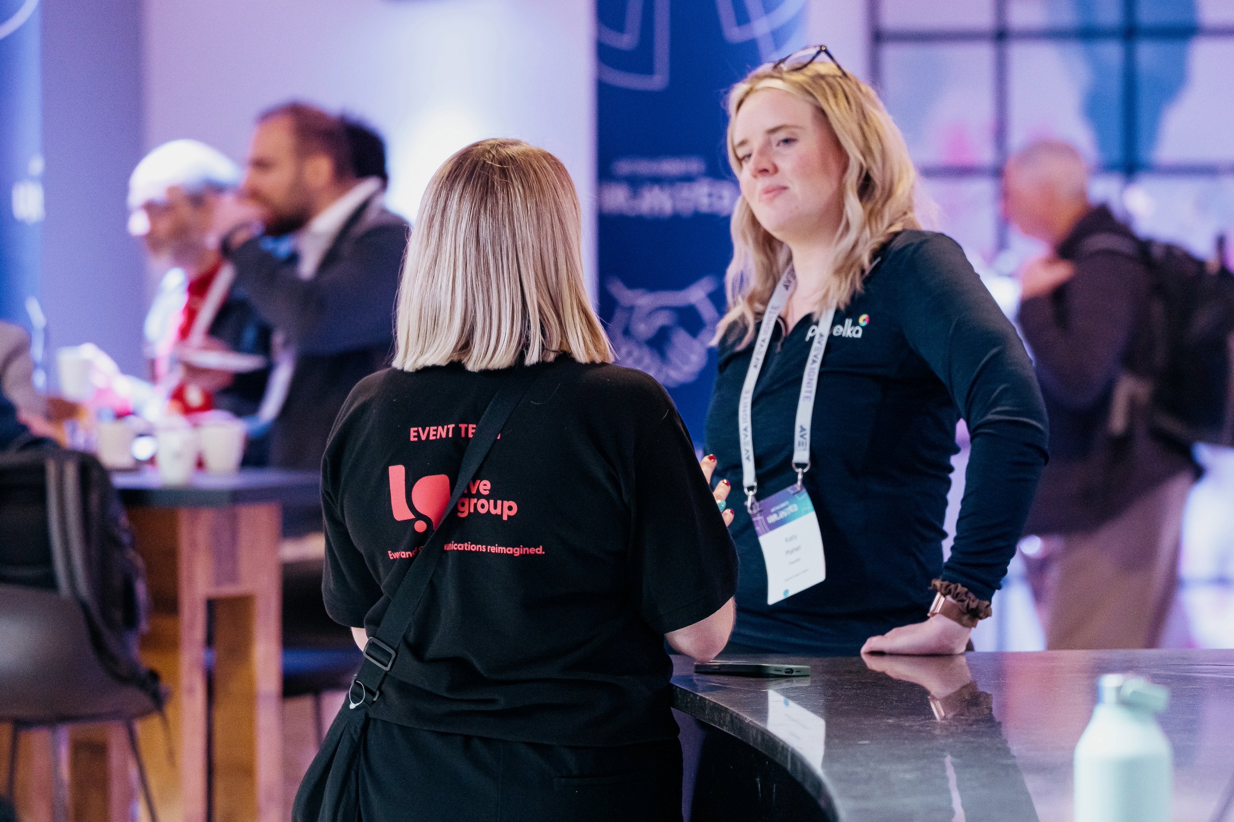 Live Group event manager overseeing on-site event management during a live event, representing a leading event agency.