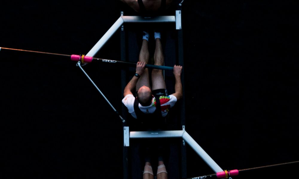 Boat team collaborating as a metaphor for improved organisational culture through events.