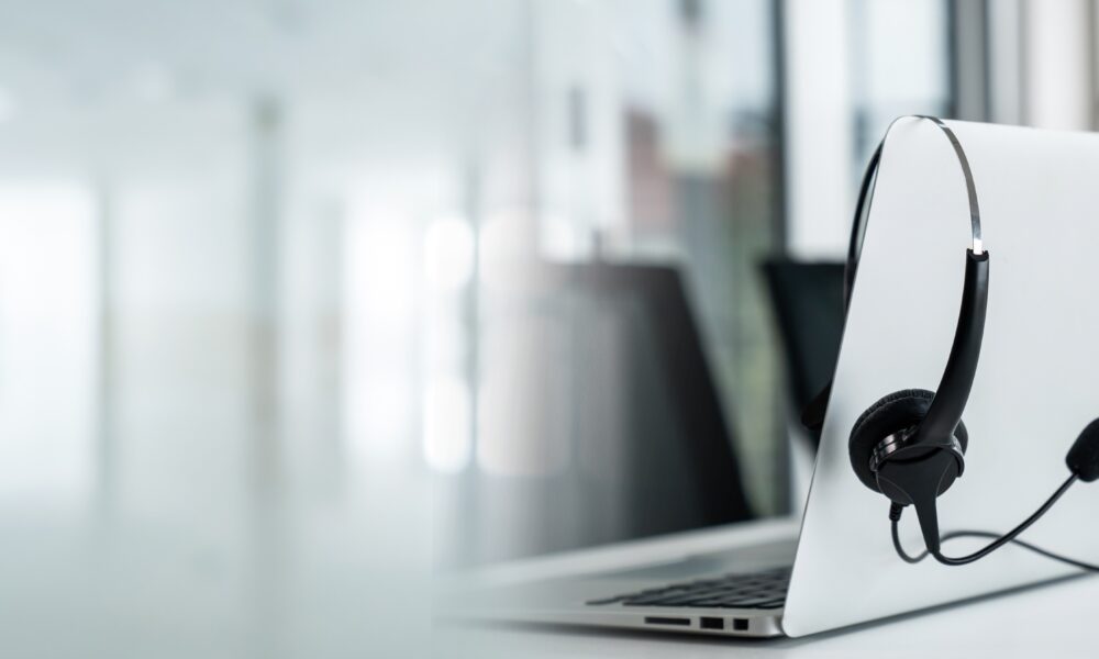 Headset and customer support equipment at call center ready for actively service . Corporate business help desk and telephone assistance concept .