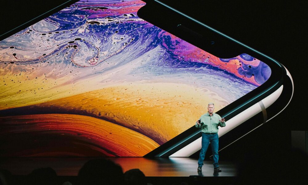 Speaker at event talking about tech, signifying the paradox between event and employee engagement and technology.