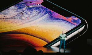 Speaker at event talking about tech, signifying the paradox between event and employee engagement and technology.