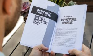 Person reading a storytelling book, illustrating the role of storytelling in internal communications and employee engagement within organisations.