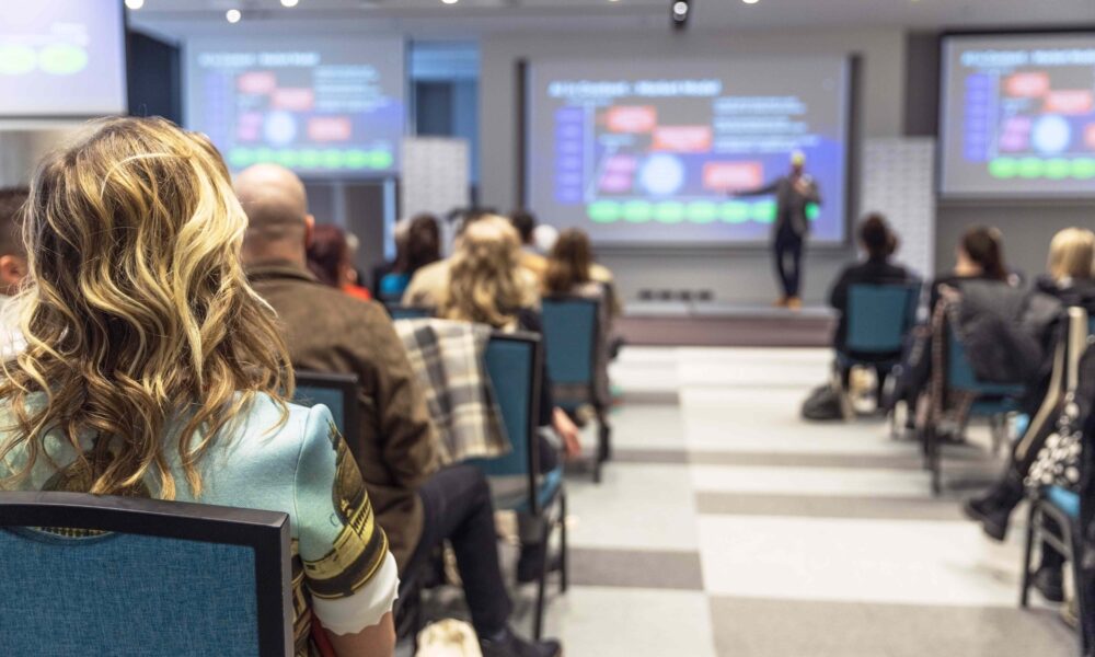 A UK hybrid event with delegates in plenary room with livestreaming and interactive event elements.