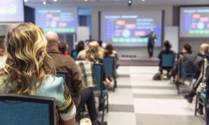 A UK hybrid event with delegates in plenary room with livestreaming and interactive event elements.