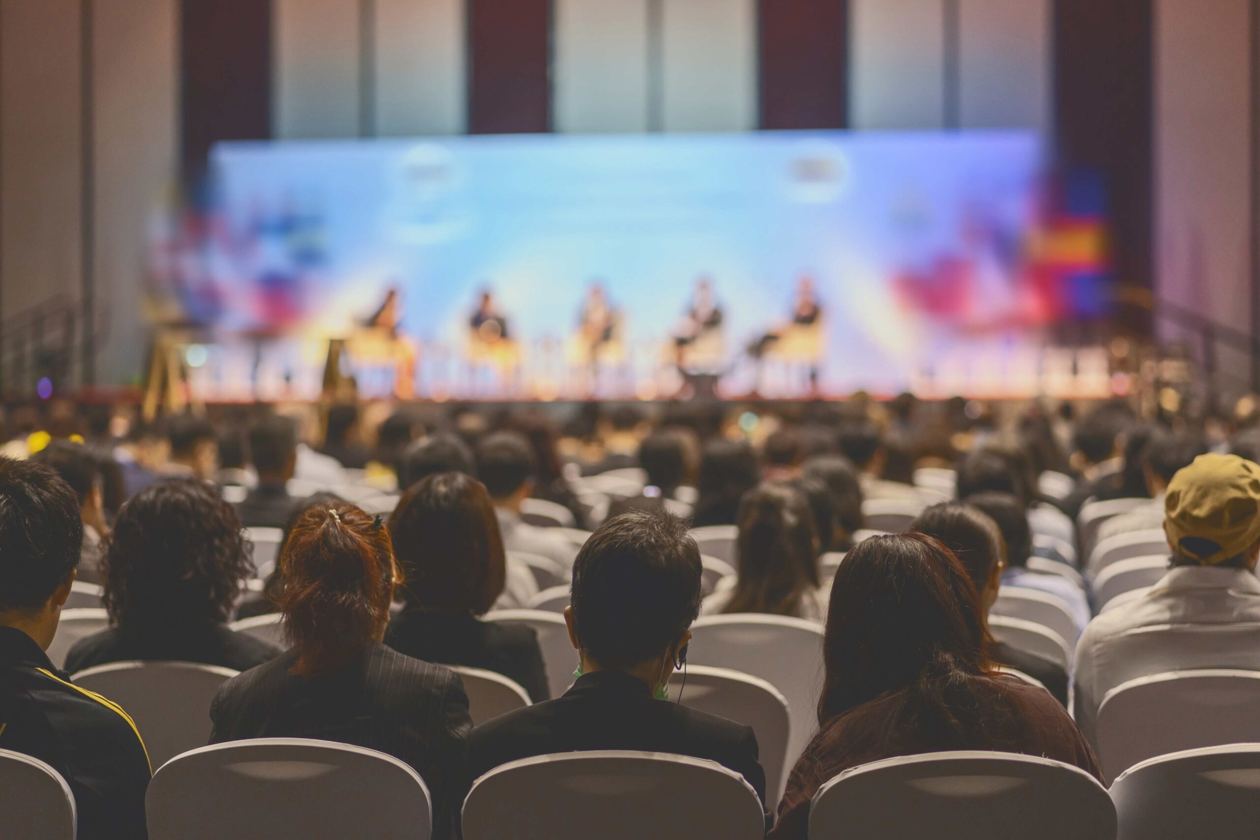 An in-person event audience seated for a live seminar.