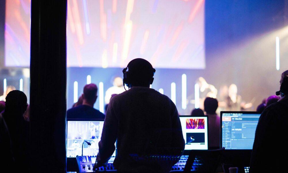 Corporate event with a producer at mixing desk. Example of compliant, regulated event.