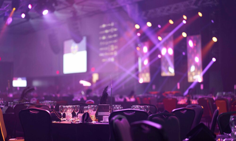 Corporate awards ceremony in event venue.