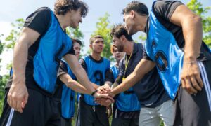 Team at corporate sports day. Example of team building event.