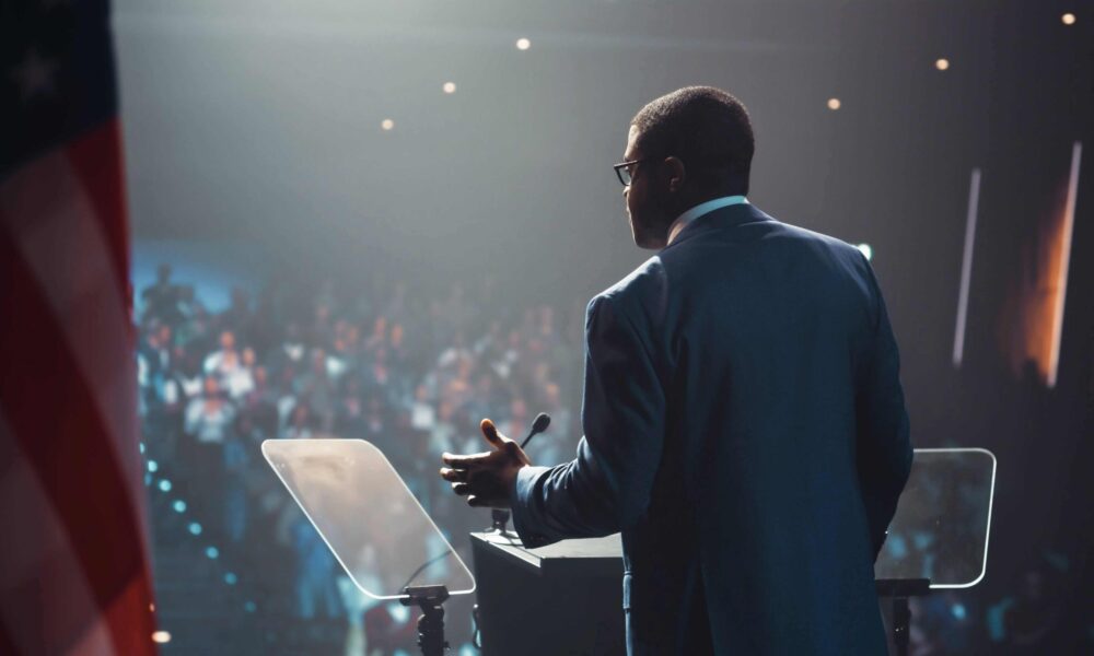 Public sector professional speaking at an event. Example of successful agency procurement.