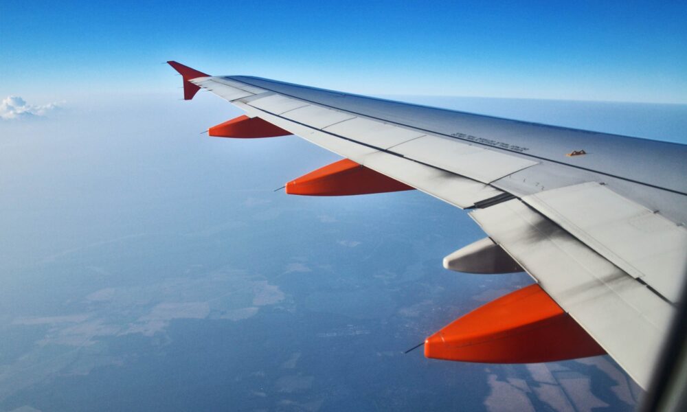 A plane wing shot signifying corporate incentive travel.